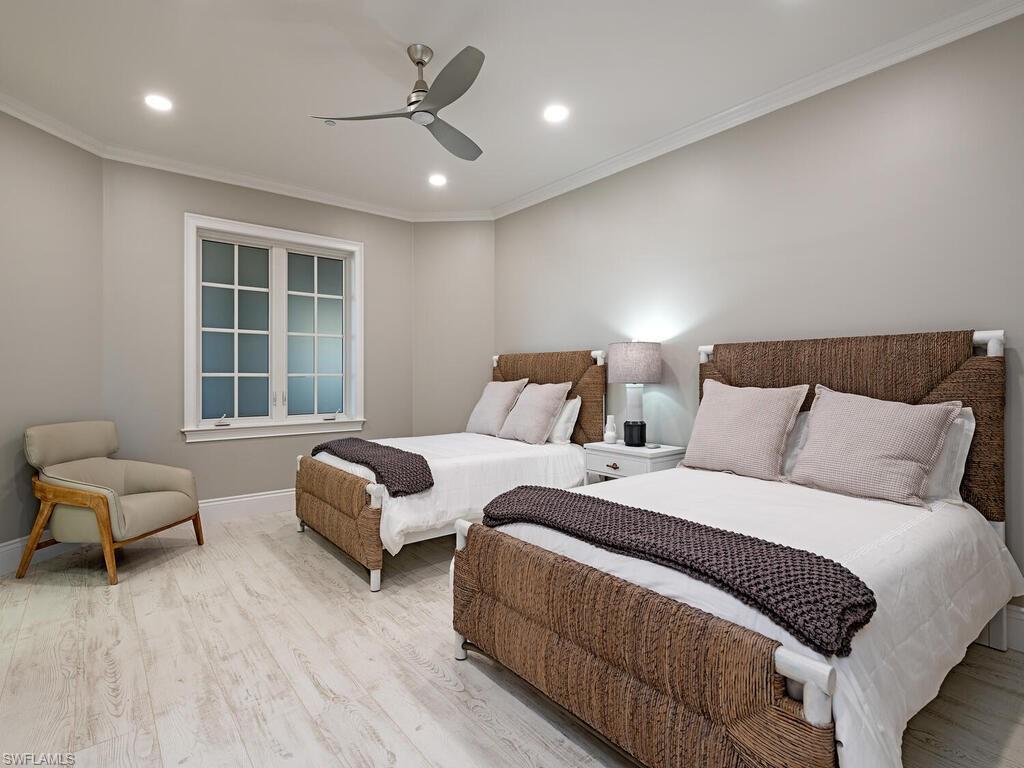 627 6th Avenue South, Unit B302 Naples, FL 34102 - Photo 9 of 14 a bedroom with two beds and a large window