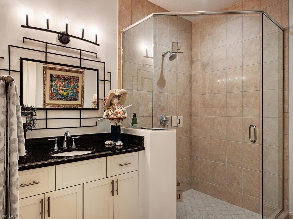 627 6th Avenue South, Unit B302 Naples, FL 34102 - Photo 10 of 14 a bathroom with a shower and a sink