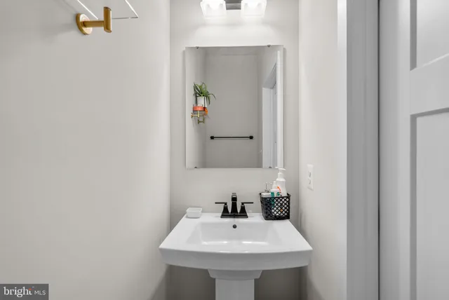 a kitchen with stainless steel appliances a refrigerator a stove a sink a dining table and chairs