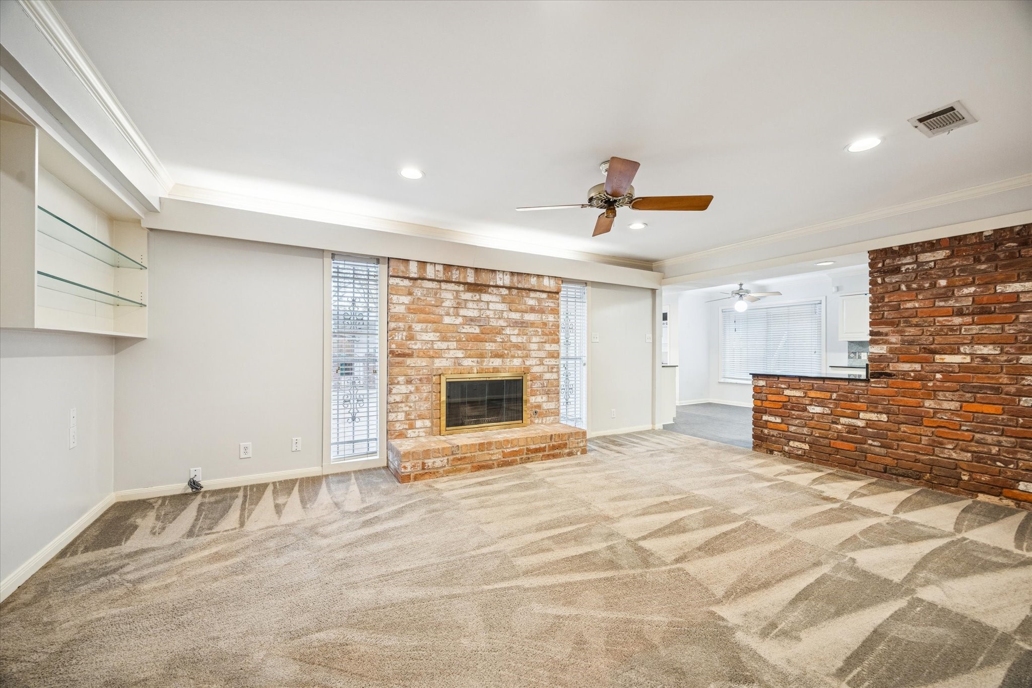 9022 Timberside Drive Houston, TX 77025 - Photo 3 of 10 a view of an empty room with a fireplace and a window