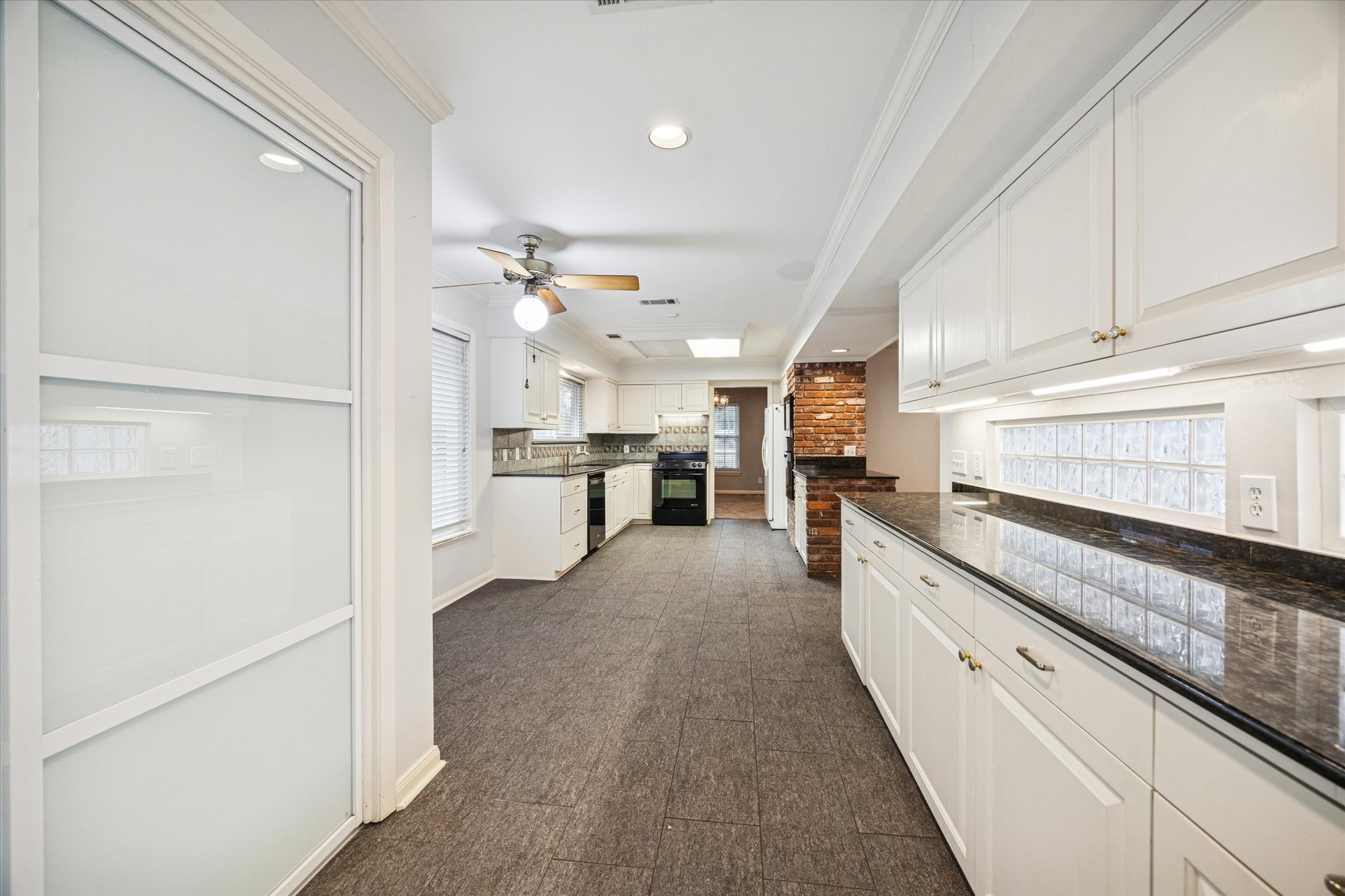 9022 Timberside Drive Houston, TX 77025 - Photo 5 of 10 a large white kitchen with cabinets and stainless steel appliances
