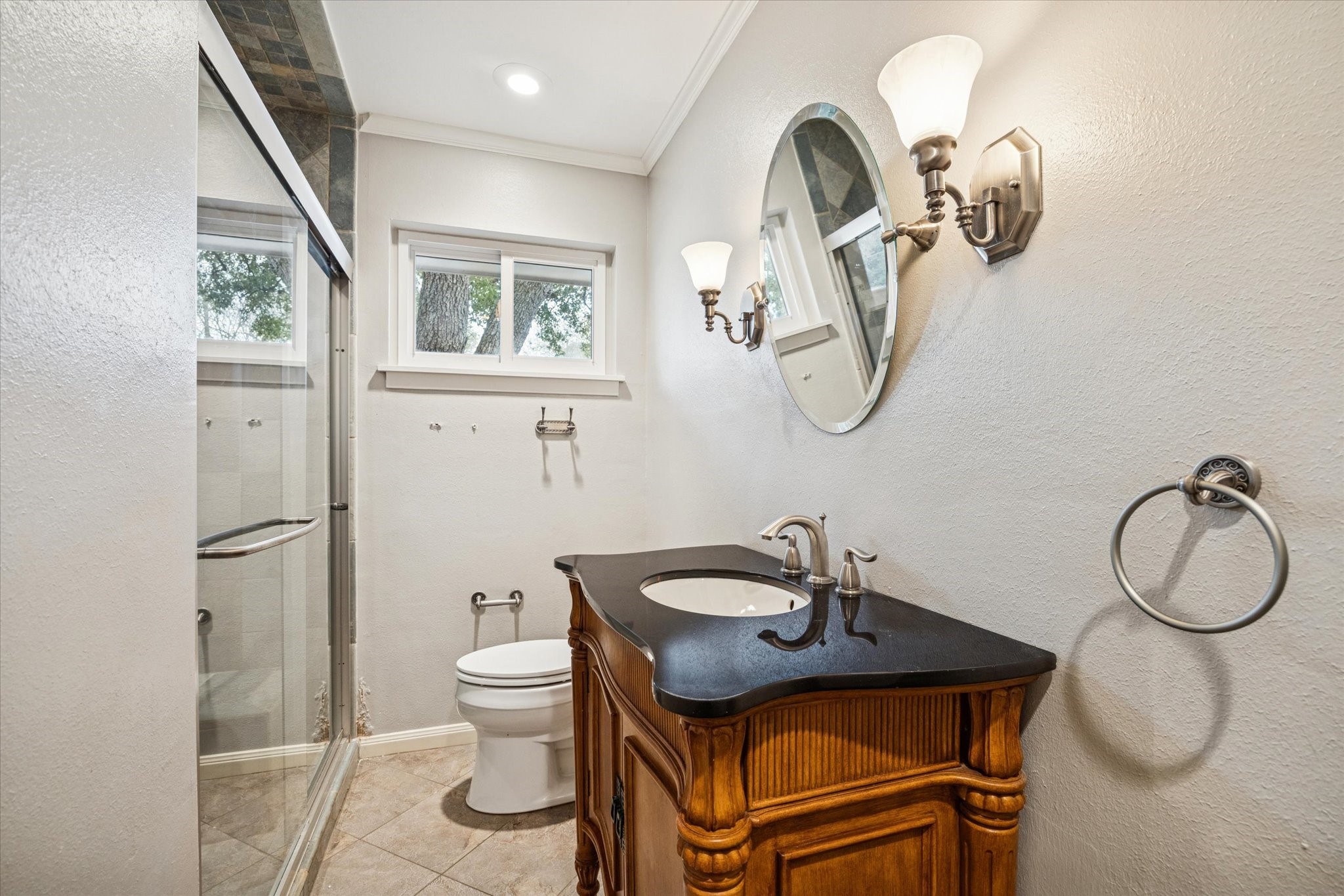 9022 Timberside Drive Houston, TX 77025 - Photo 9 of 10 a bathroom with a toilet a sink and a mirror