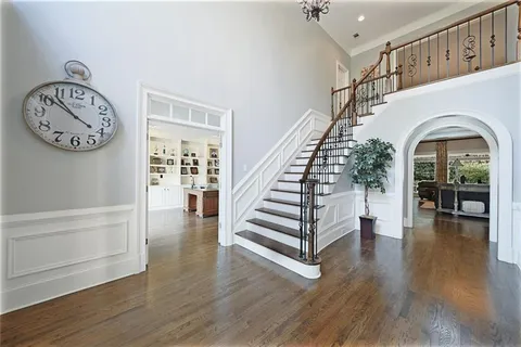 a view of a dining room with furniture a chandelier and wooden floor