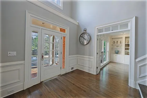 a spacious bedroom with a bed and a chandelier