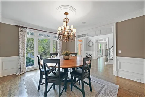 a spacious en suite bathroom with a granite countertop sink and a mirror