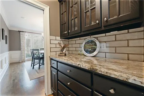 a en suite bathroom with a granite countertop double vanity sink and a mirror