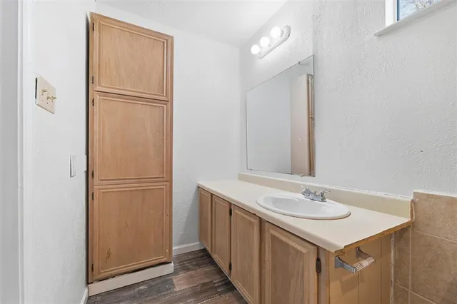 a bathroom with a sink mirror and shower