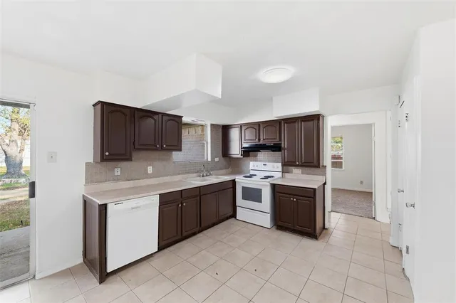 a large kitchen with cabinets and stainless steel appliances