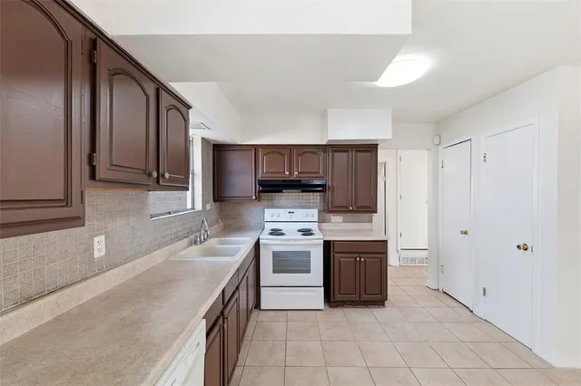 a view of a kitchen with a sink and window