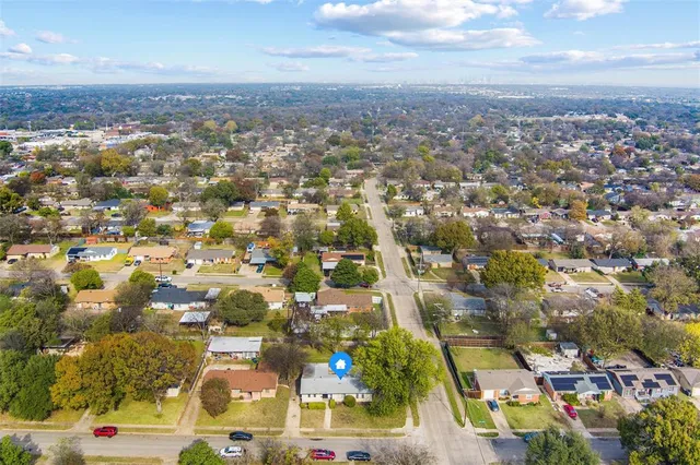 an aerial view of residential houses with city view