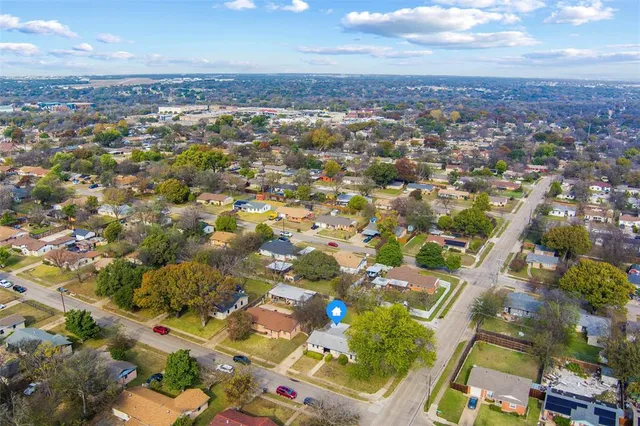 an aerial view of residential houses with city view
