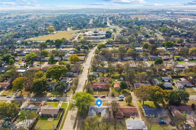 an aerial view of residential houses with city view