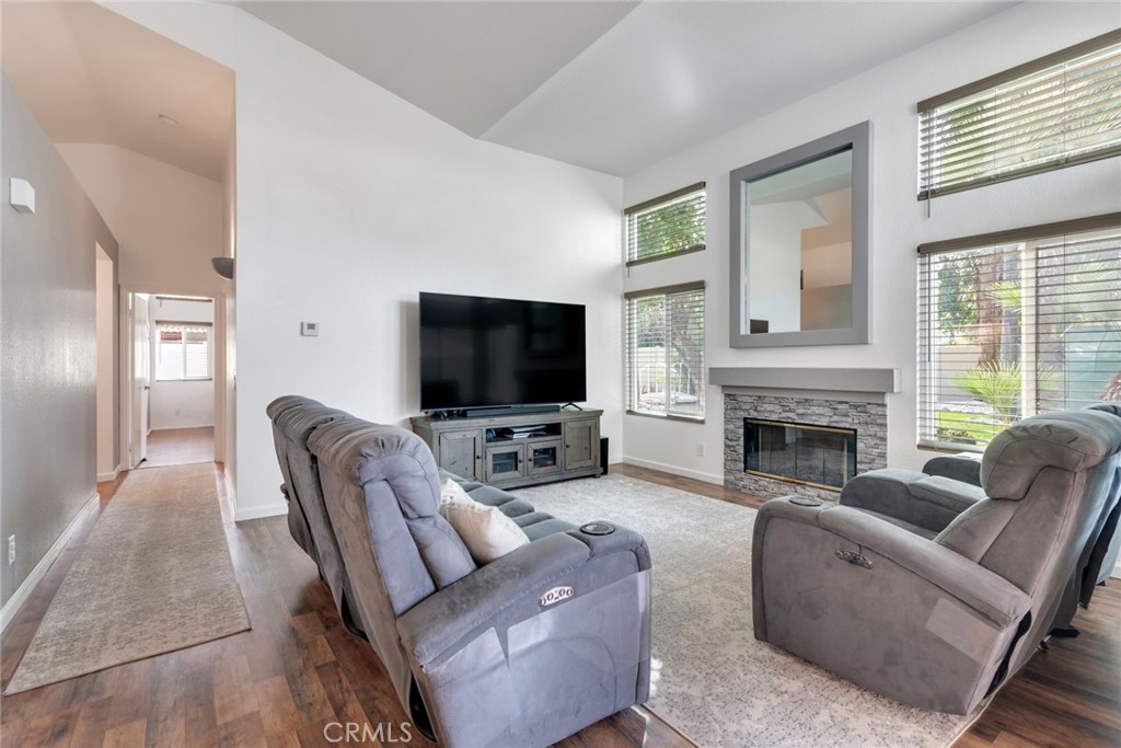 705 Fuchsia Lane Perris, CA 92571 - Photo 11 of 29 a living room with furniture a flat screen tv and a fireplace