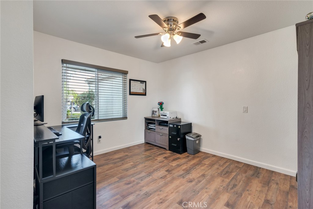 705 Fuchsia Lane Perris, CA 92571 - Photo 14 of 29 a view of a workspace with furniture and a window