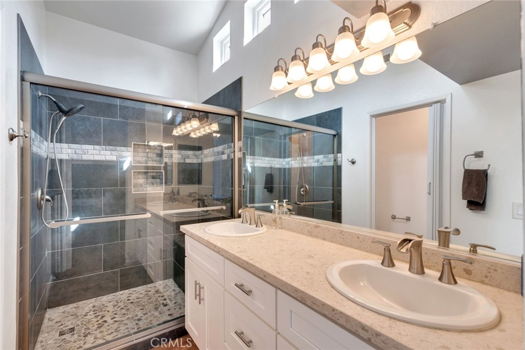 705 Fuchsia Lane Perris, CA 92571 - Photo 18 of 29 a bathroom with a sink a light fixture and a mirror
