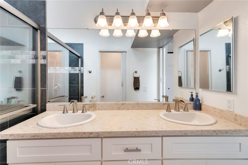 705 Fuchsia Lane Perris, CA 92571 - Photo 19 of 29 a bathroom with a granite countertop double vanity sinks a vanity and a mirror