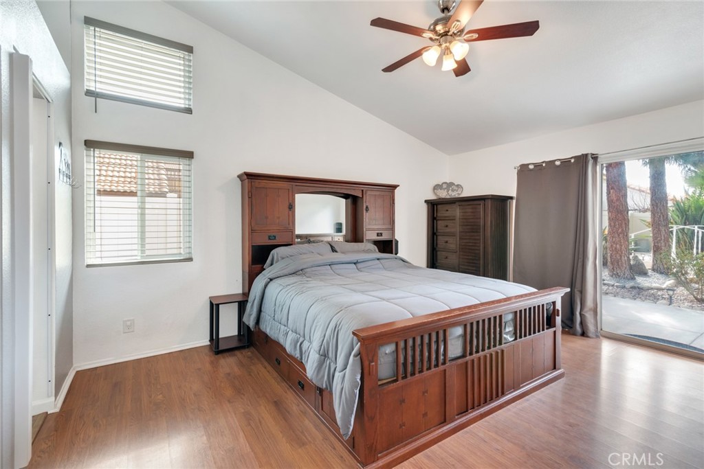 705 Fuchsia Lane Perris, CA 92571 - Photo 20 of 29 a bedroom with a large bed and a chandelier