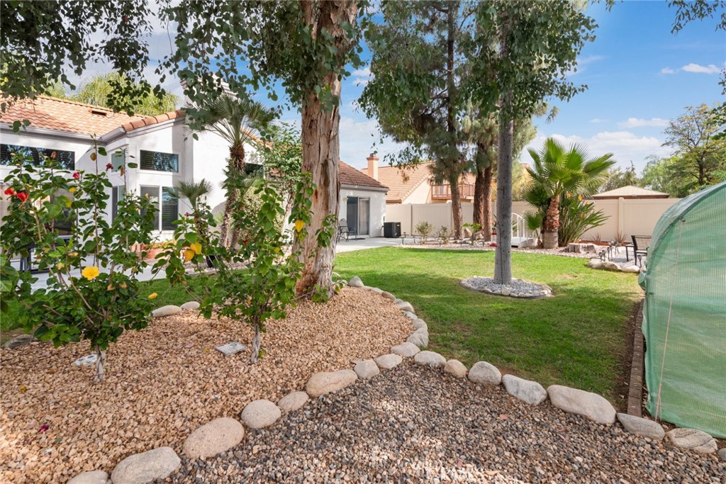 705 Fuchsia Lane Perris, CA 92571 - Photo 21 of 29 a view of a yard in front of a house with a tree