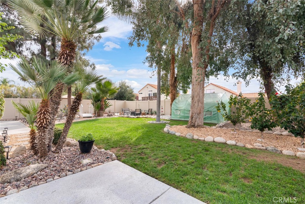 705 Fuchsia Lane Perris, CA 92571 - Photo 22 of 29 a view of a backyard with tree s