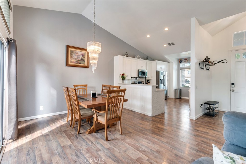 705 Fuchsia Lane Perris, CA 92571 - Photo 5 of 29 a view of a dining room with furniture and wooden floor