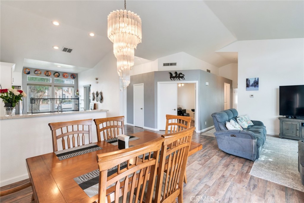705 Fuchsia Lane Perris, CA 92571 - Photo 7 of 29 a living room with furniture chandelier and a flat screen tv