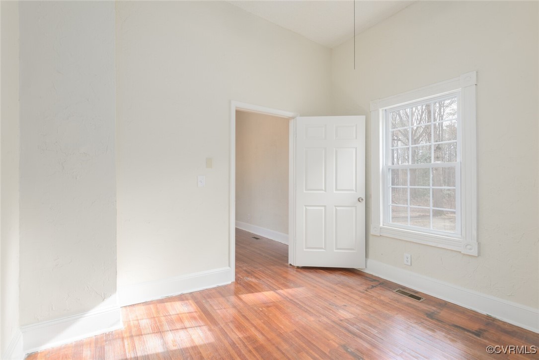 7808 Wells Road Ford, VA 23850 - Photo 11 of 41 an empty room with wooden floor and windows