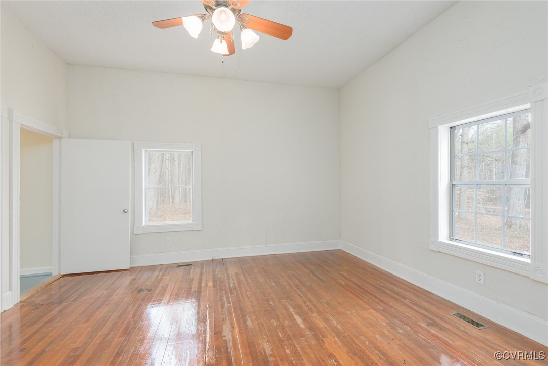 7808 Wells Road Ford, VA 23850 - Photo 12 of 41 an empty room with wooden floor and windows