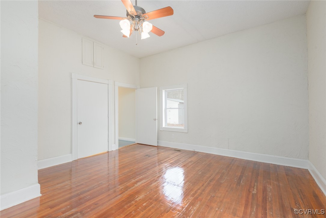 7808 Wells Road Ford, VA 23850 - Photo 13 of 41 an empty room with wooden floor fan and windows