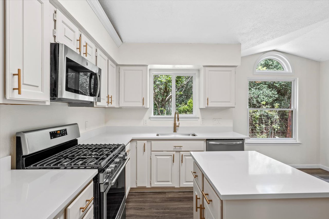4004 Danli Lane Austin, TX 78749 - Photo 25 of 40 a kitchen with stainless steel appliances kitchen island a stove a sink and a microwave