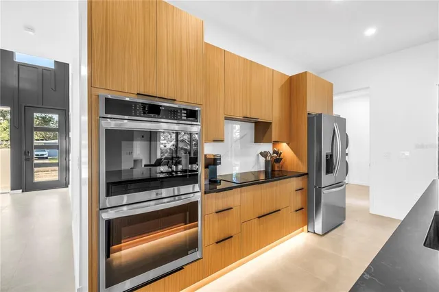 a kitchen with stainless steel appliances a refrigerator and a stove