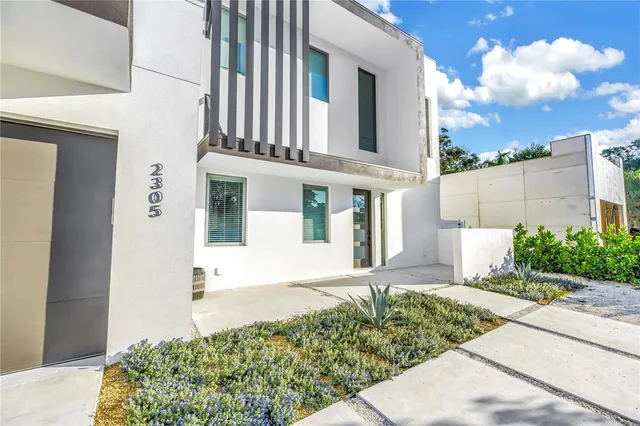 a front view of a house with garden