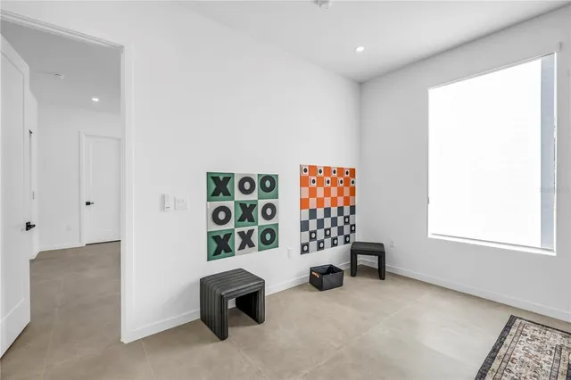 a bedroom with a balcony a bed and a painting on the wall