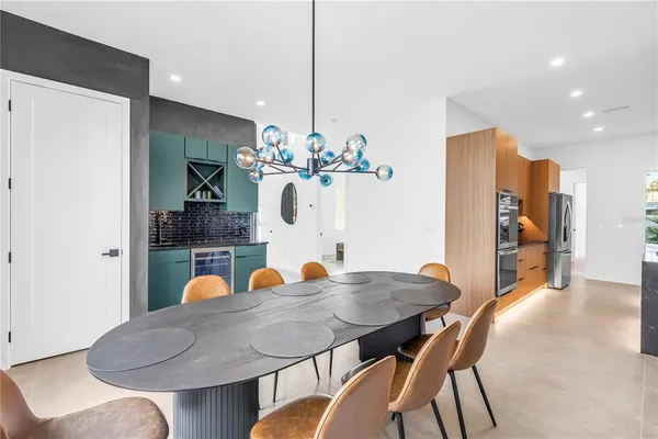 a kitchen with stainless steel appliances a refrigerator and a stove top oven