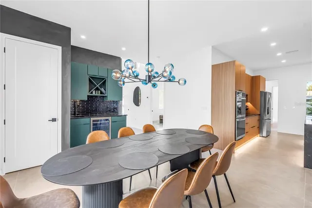 a kitchen with stainless steel appliances a refrigerator and a stove top oven
