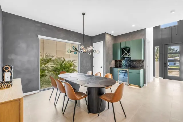 a kitchen with stainless steel appliances granite countertop a sink a stove and a wooden floors