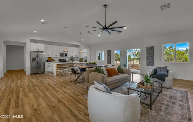 a living room with furniture and a wooden floor