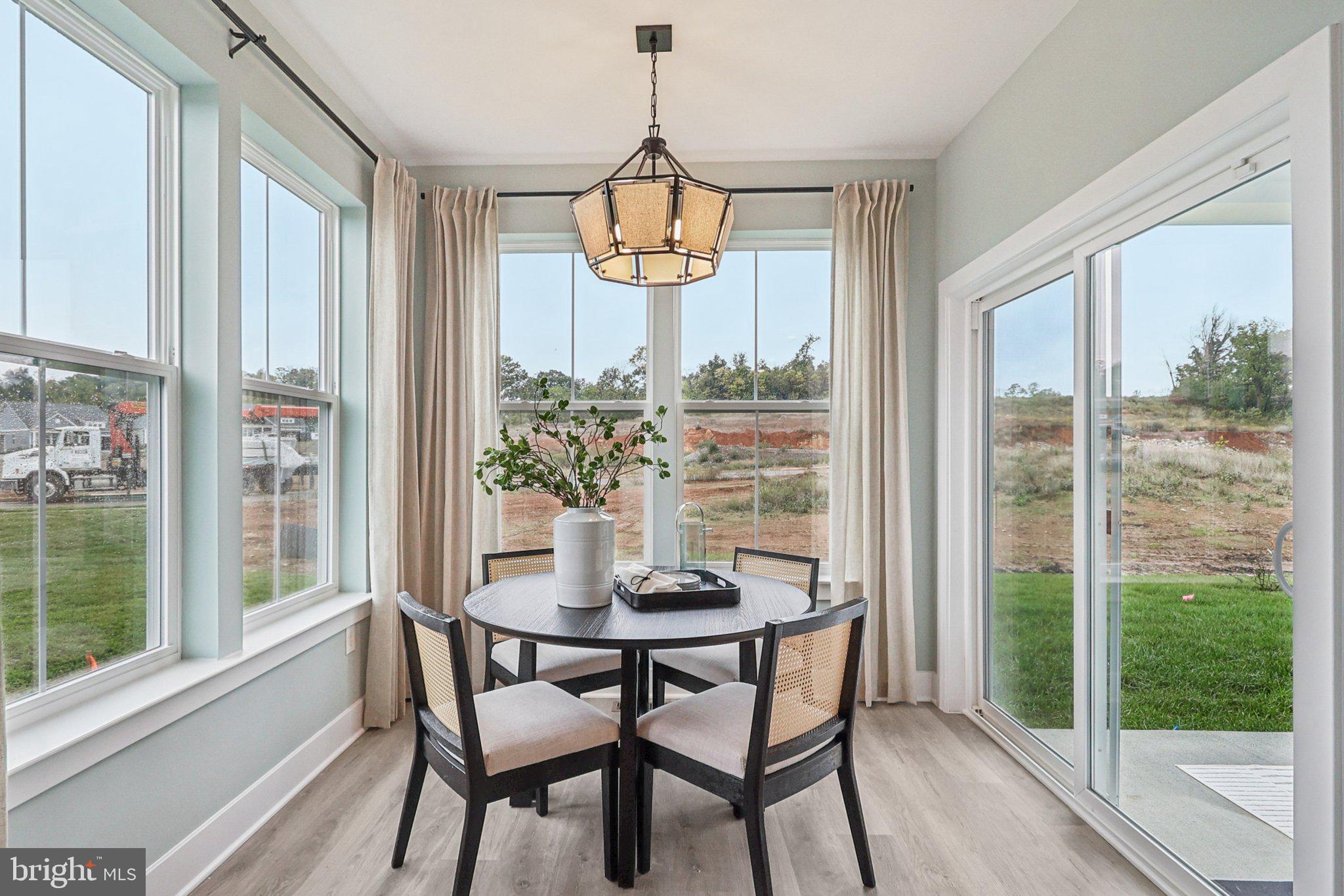 111 Hydrangea Way Winchester, VA 22602 - Photo 13 of 46 a dining room with furniture window and wooden floor