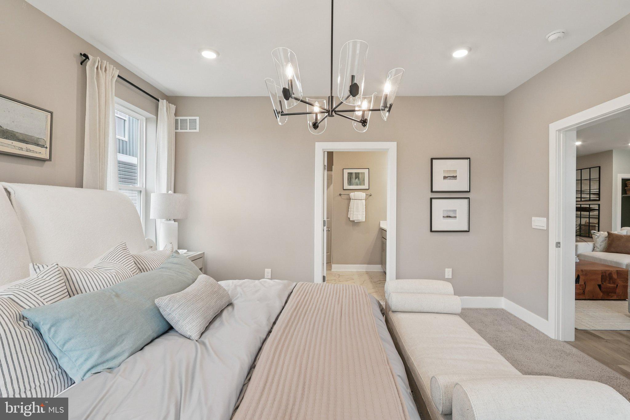 111 Hydrangea Way Winchester, VA 22602 - Photo 39 of 46 a bedroom with a large bed and a chandelier