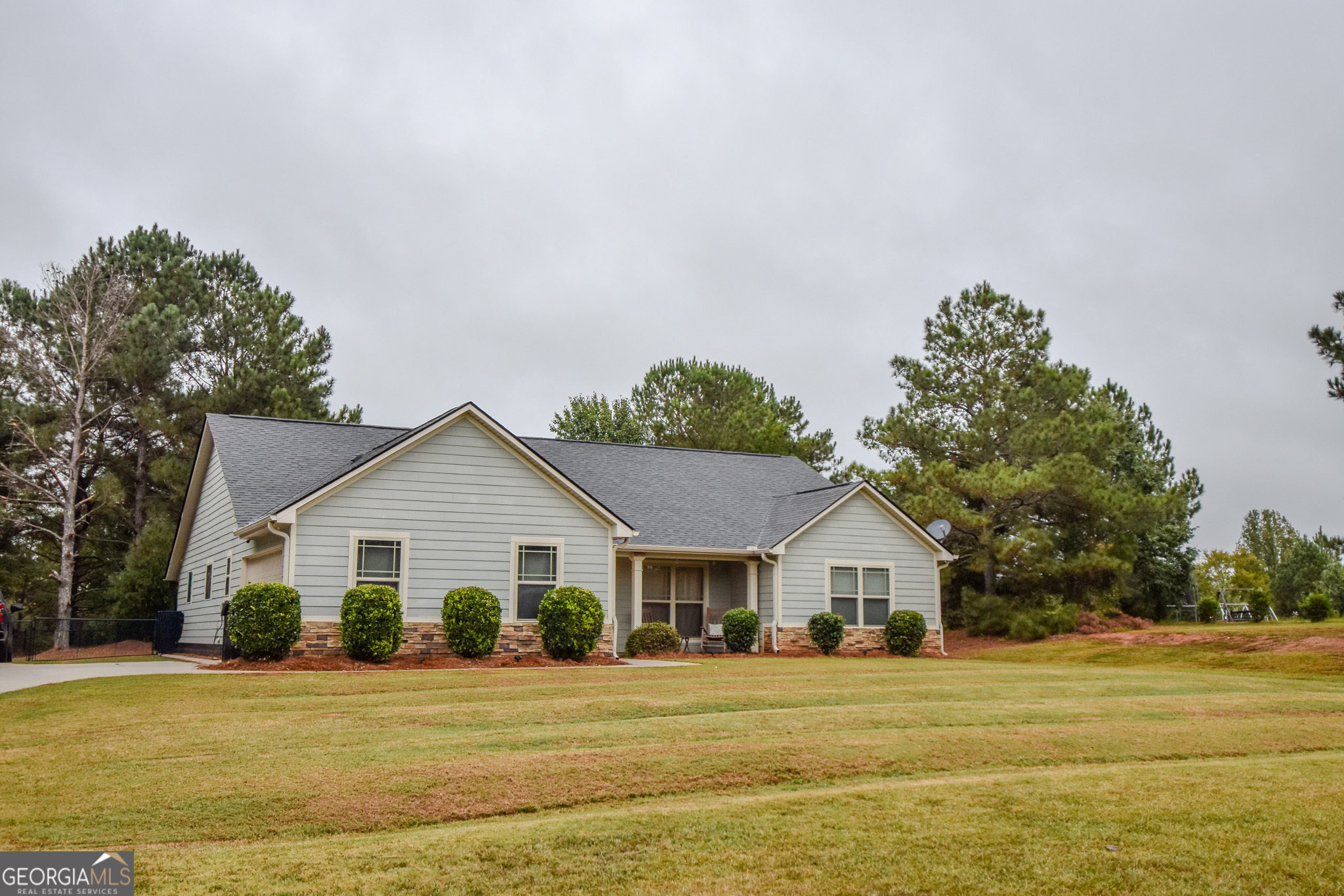 1946 Highway 362 Williamson, GA 30292 - Photo 15 of 104 a front view of a house with a yard and trees
