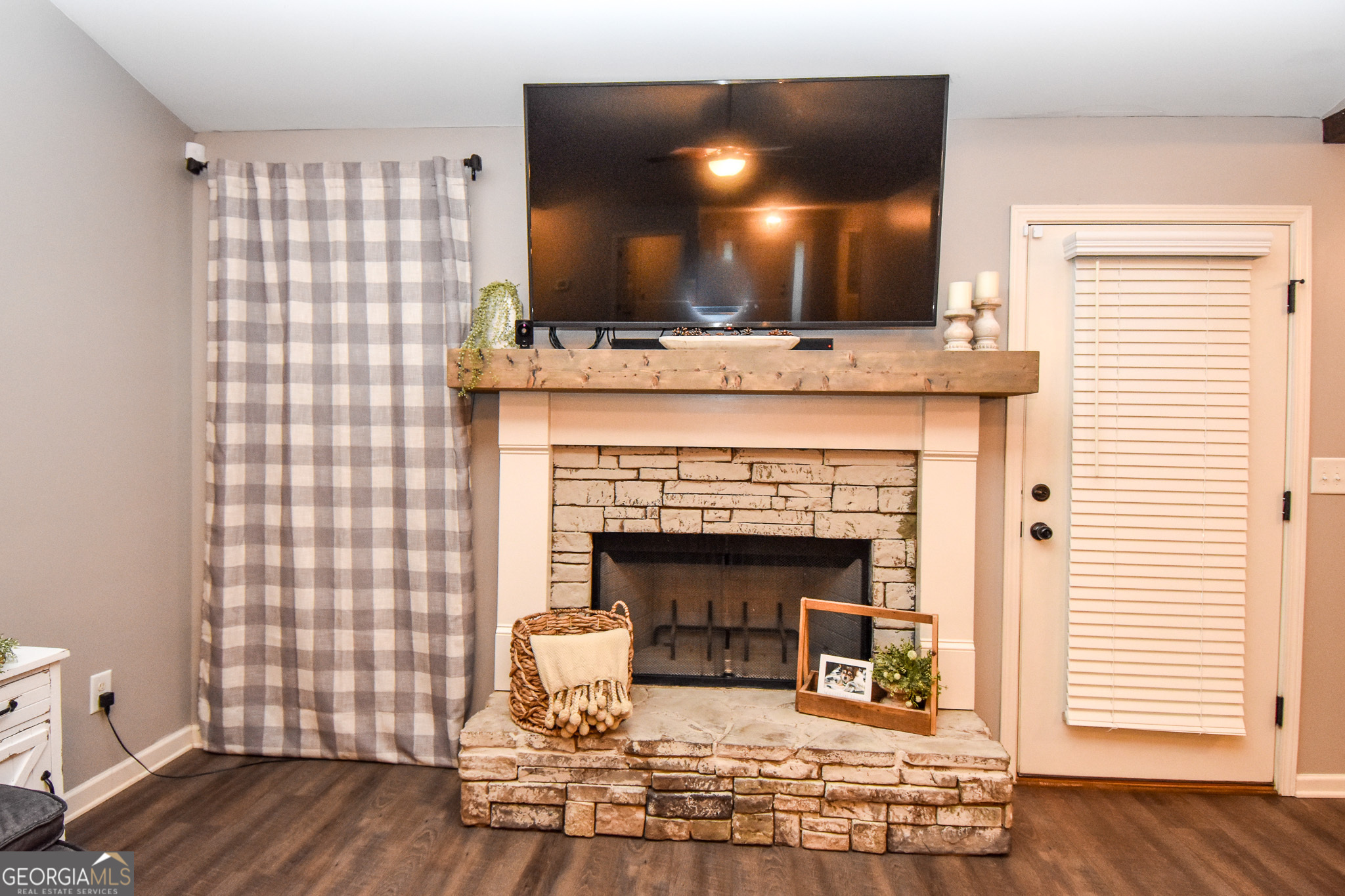 1946 Highway 362 Williamson, GA 30292 - Photo 38 of 104 a living room with a fireplace and wooden floor