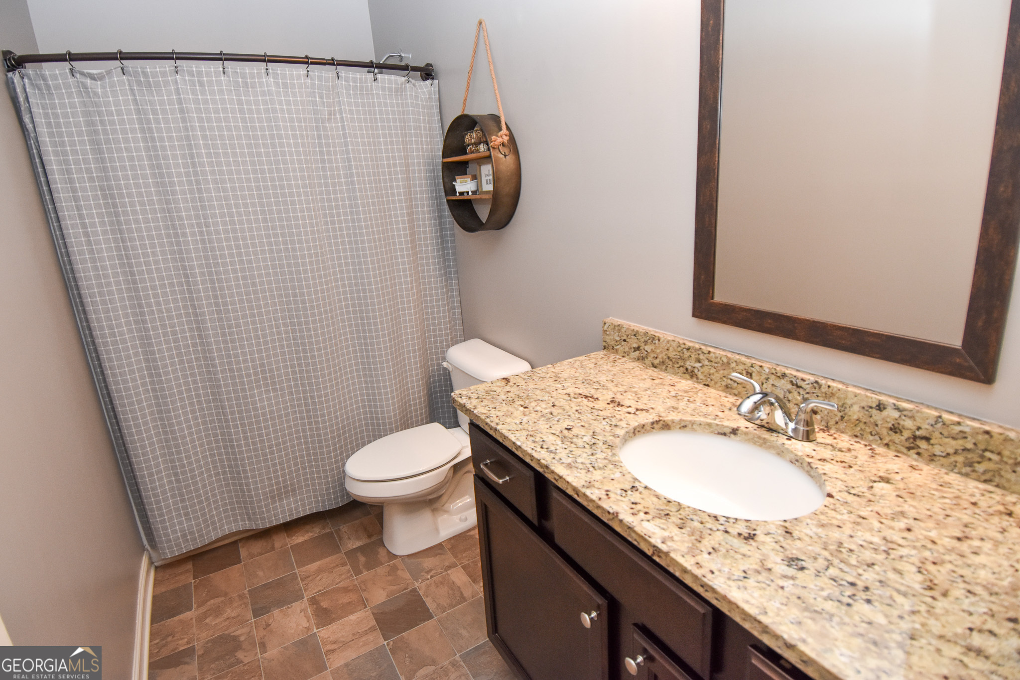 1946 Highway 362 Williamson, GA 30292 - Photo 77 of 104 a bathroom with a granite countertop sink toilet and a mirror