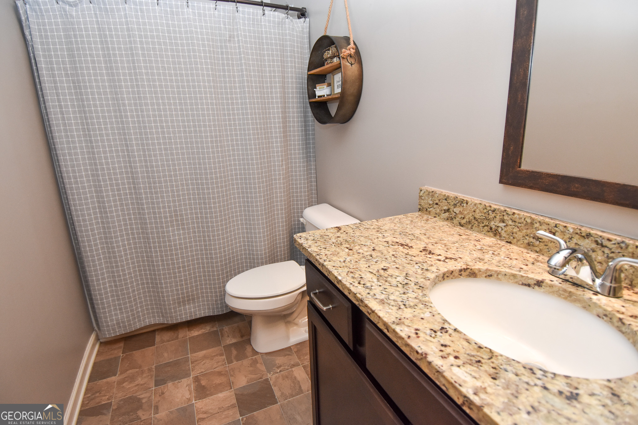 1946 Highway 362 Williamson, GA 30292 - Photo 78 of 104 a bathroom with a granite countertop toilet sink and mirror