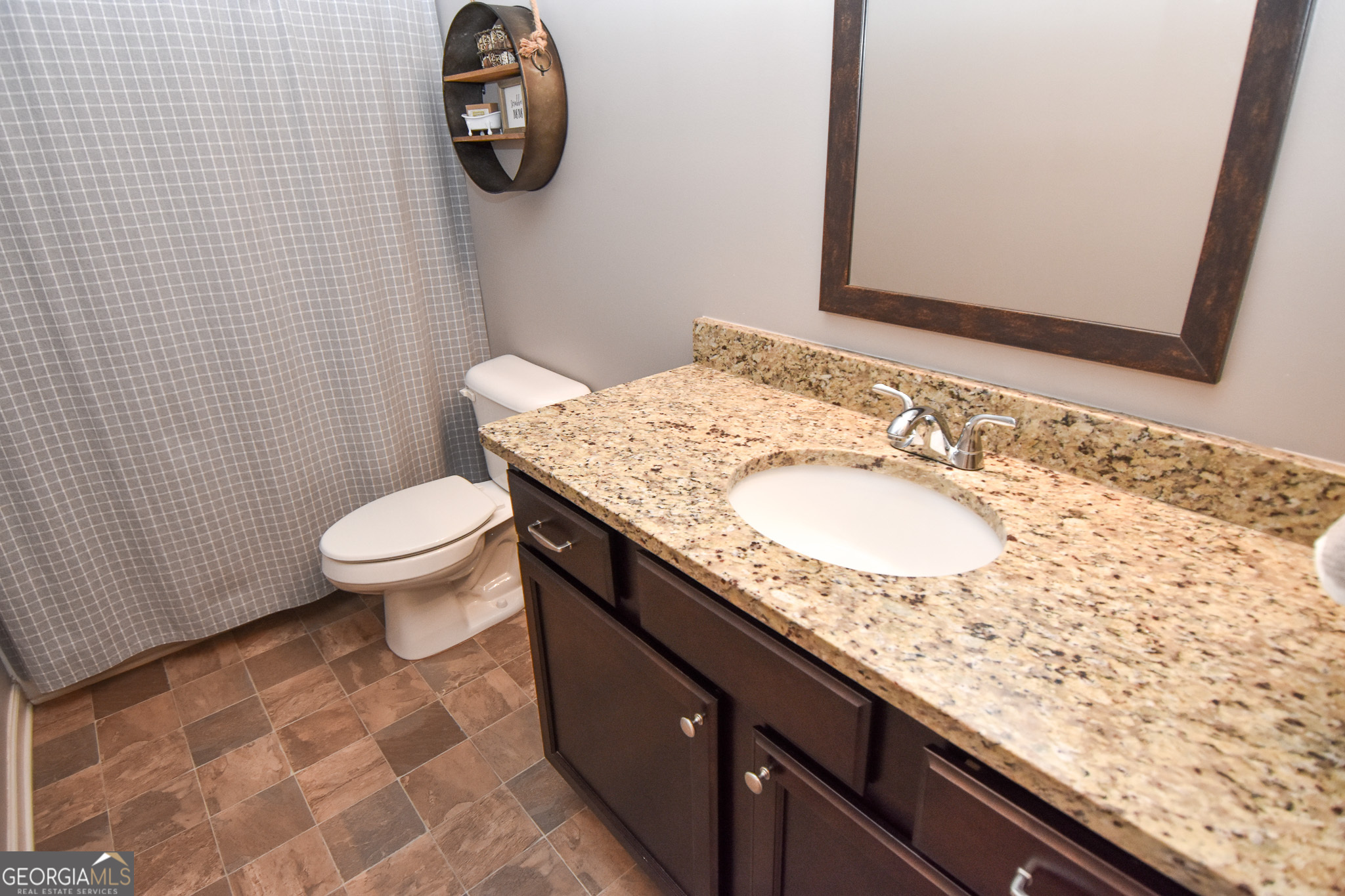 1946 Highway 362 Williamson, GA 30292 - Photo 86 of 104 a bathroom with a granite countertop toilet sink and mirror