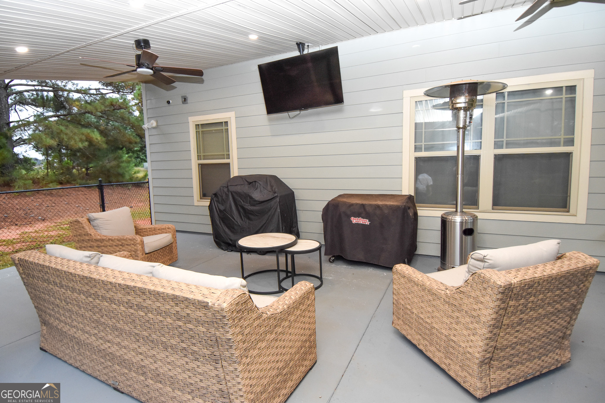 1946 Highway 362 Williamson, GA 30292 - Photo 94 of 104 a living room with furniture a flat screen tv and a floor to ceiling window