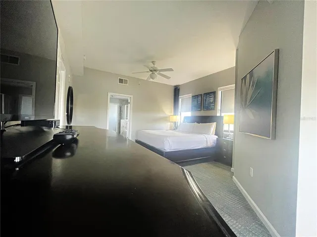 a spacious bathroom with a glass shower door and a sink