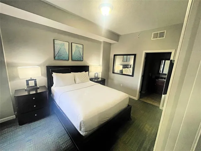 a bathroom with a granite countertop sink a mirror and shower