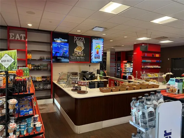an aerial view of a house with a garden and lake view