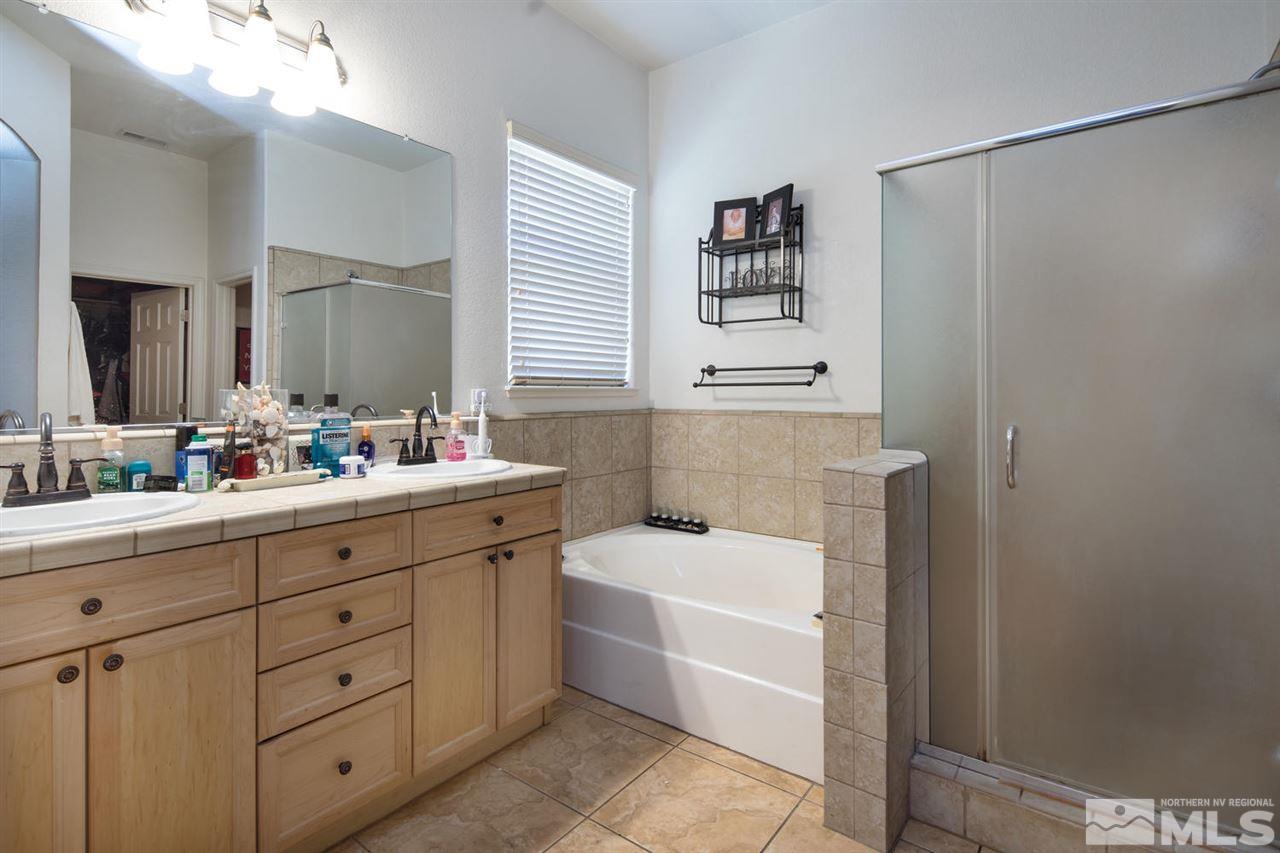 1655 Sewell Drive Reno, NV 89521 - Photo 13 of 21 a bathroom with a tub a sink and a window