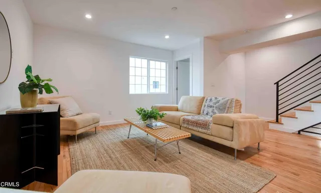 a living room with furniture and wooden floor