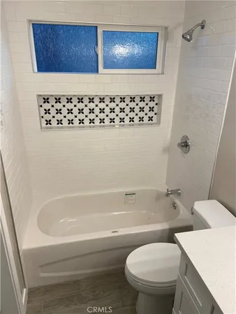 a bathroom with a toilet and a bathtub